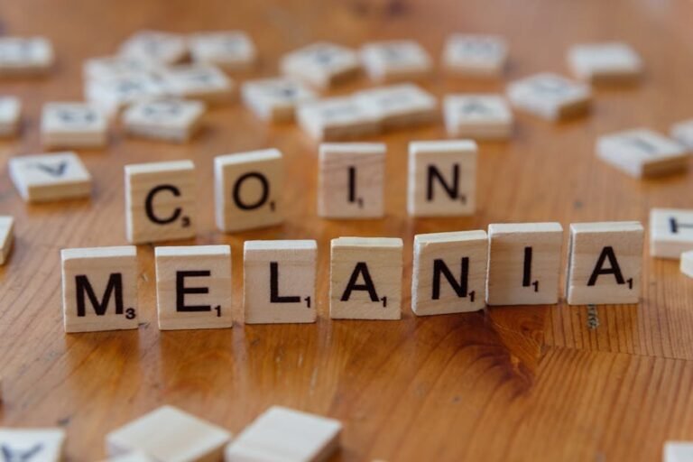 Close-up of Scrabble tiles spelling 'Melania' and 'Coin' on a wooden table, game concept.
