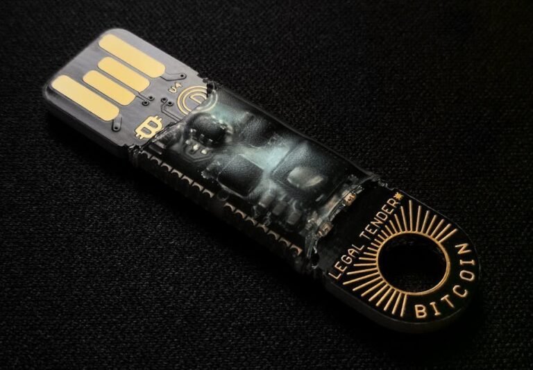 A detailed close-up of a Bitcoin-themed USB device on a black background.