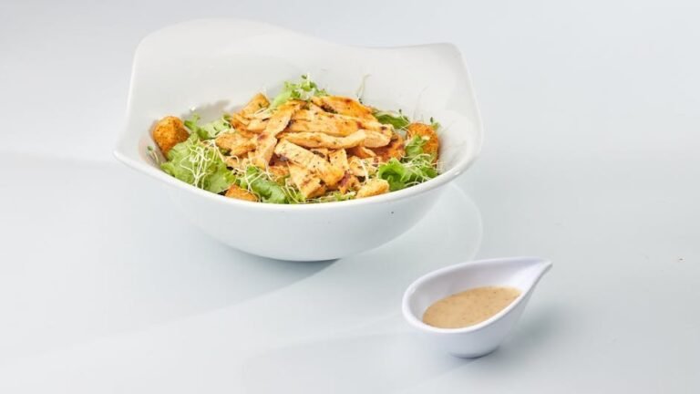 A delicious chicken Caesar salad with croutons and dressing, perfect for a healthy meal.
