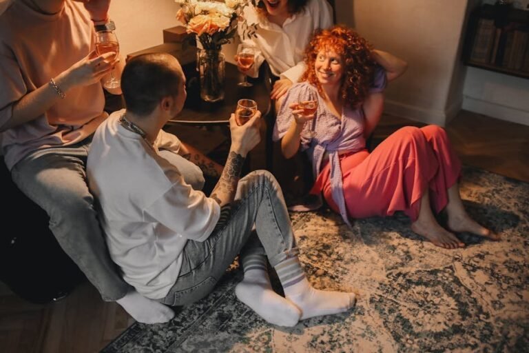 Young adults enjoying a cozy indoor evening with drinks and laughter.