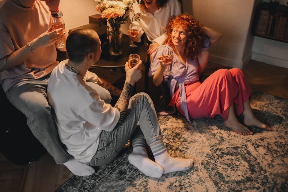 Young adults enjoying a cozy indoor evening with drinks and laughter.