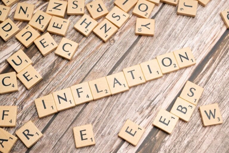 Wooden letter tiles forming the word 'inflation' on a rustic wooden surface, symbolizing economic themes.